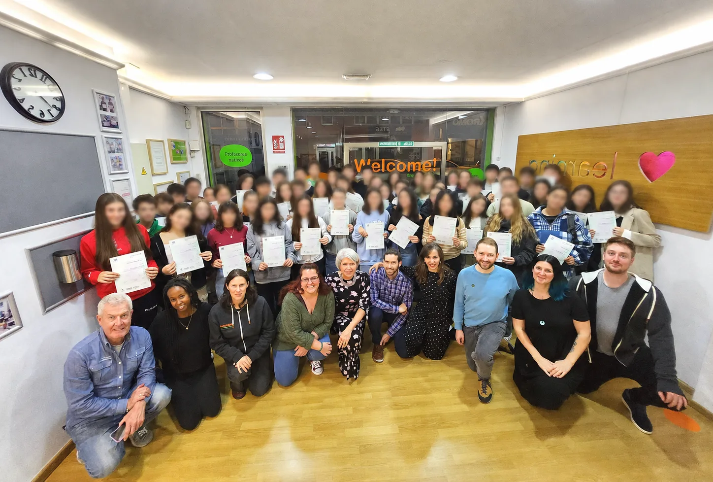 Students and teachers at Welcome English School, Lugo, holding their Cambridge certificates